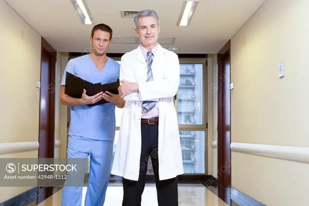 Doctor and male nurse on hospital corridor