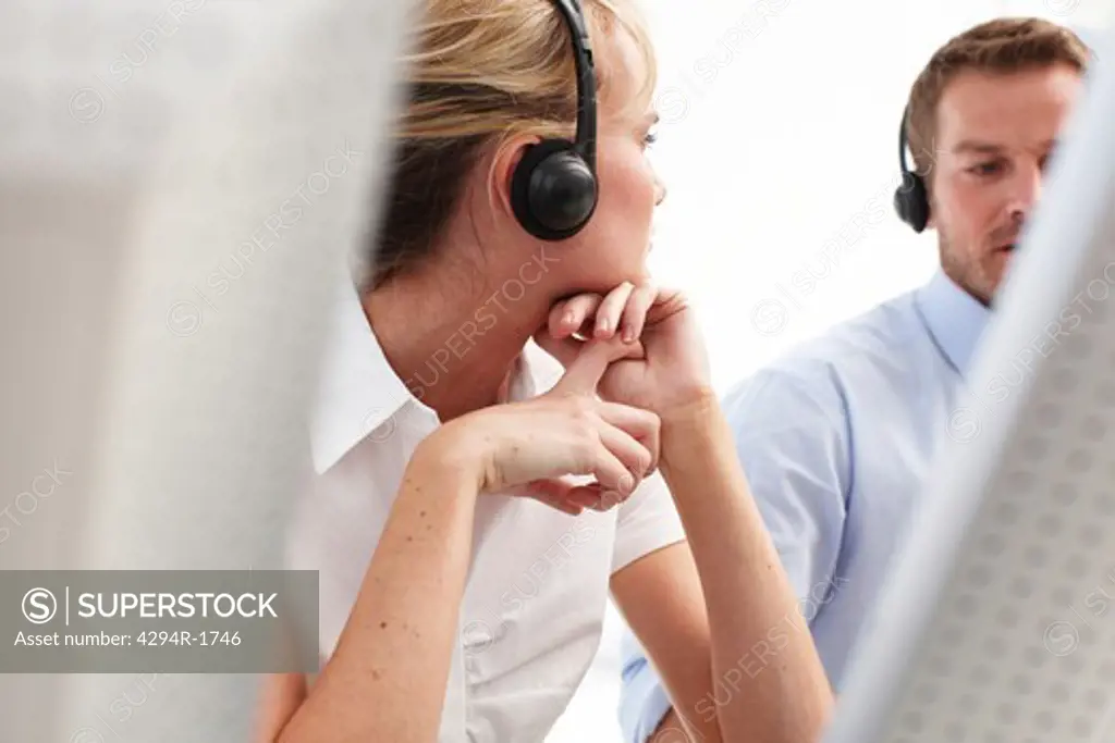 Two customer service representatives wearing headsets