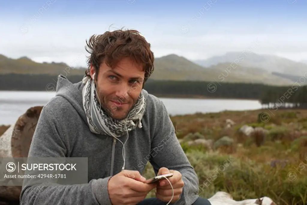 Man listening to music in remote landscape