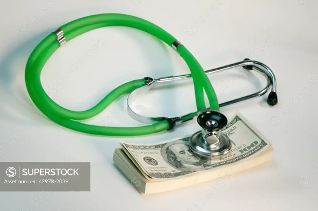 Medical stethoscope resting on dollar bills suggesting the rising costs of healthcare in the United States