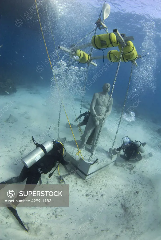 Placement of one of the sculptures at Cancun Underwater Museum, Cancun, Quintana Roo, Yucatan Peninsula, Mexico