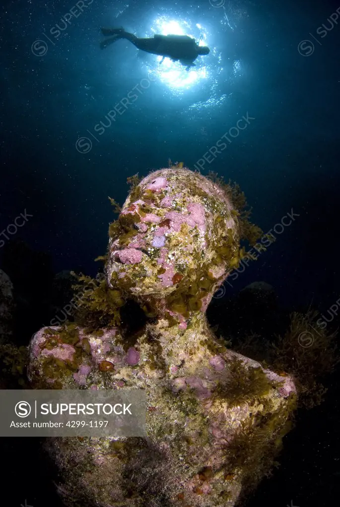 Underwater view of a sculpture with a scuba diver at Cancun Underwater Museum, Cancun, Quintana Roo, Yucatan Peninsula, Mexico