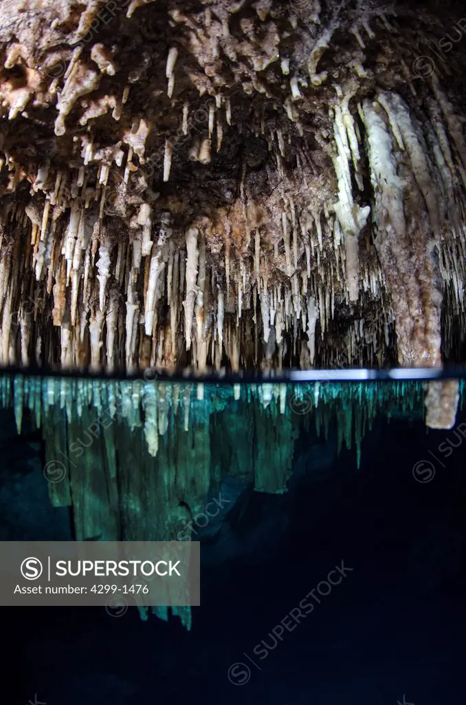Mexico, Riviera Maya, Cenote Chac Mool, Over under image of stalactite formations inside cave near Puerto Aventuras at Caribbean Sea