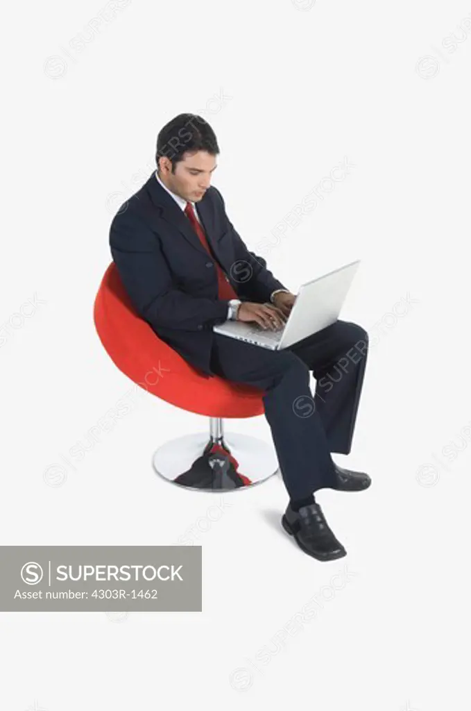 Young businessman using laptop, elevated view