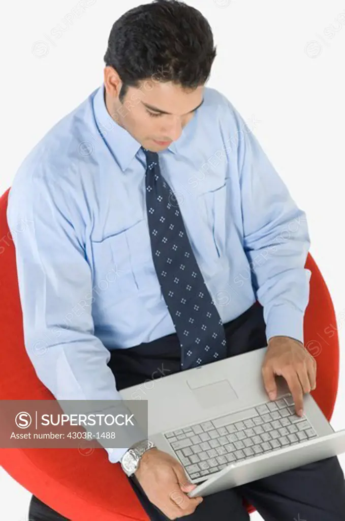 Young businessman using laptop, elevated view
