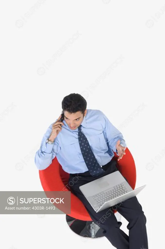 Young businessman using mobile phone, elevated view