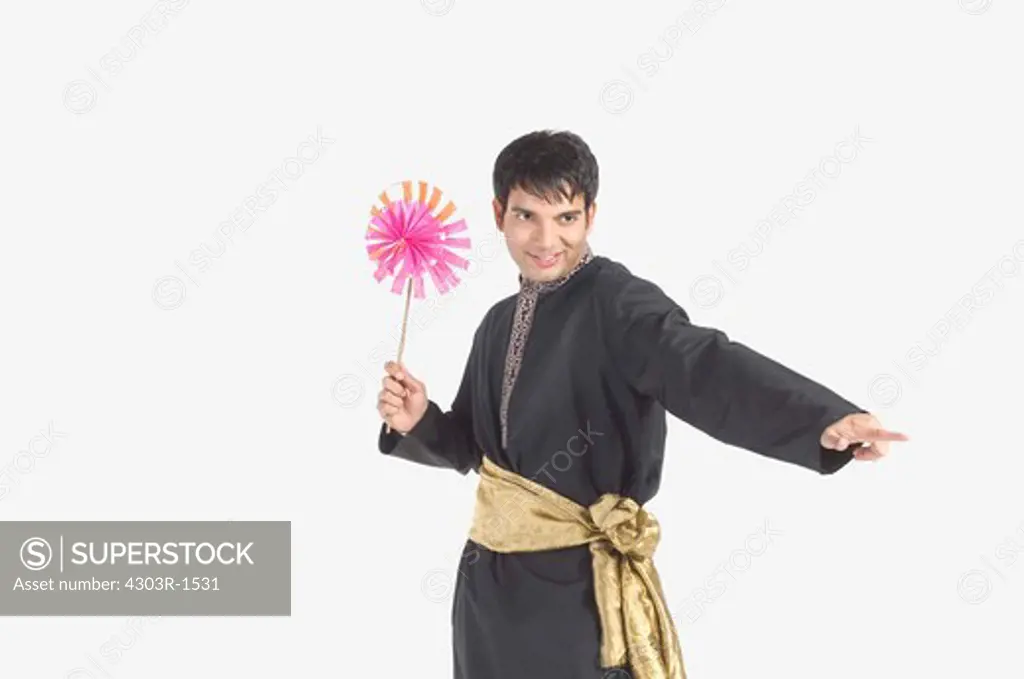 Young man holding pinwheel