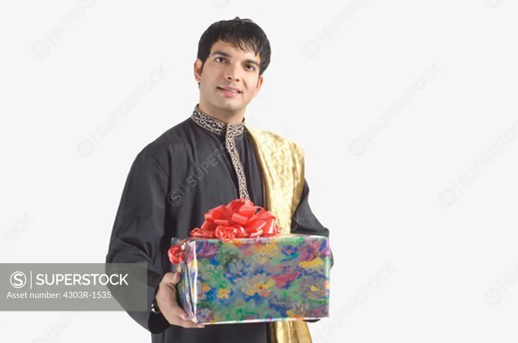 Young man holding gift, portrait