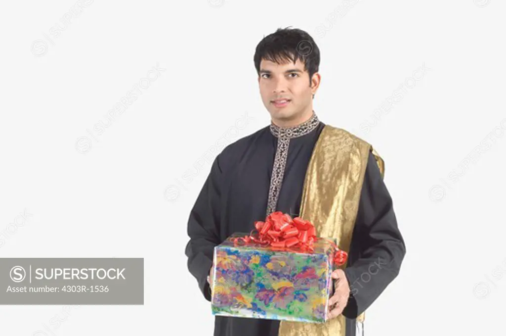 Young man holding gift, portrait