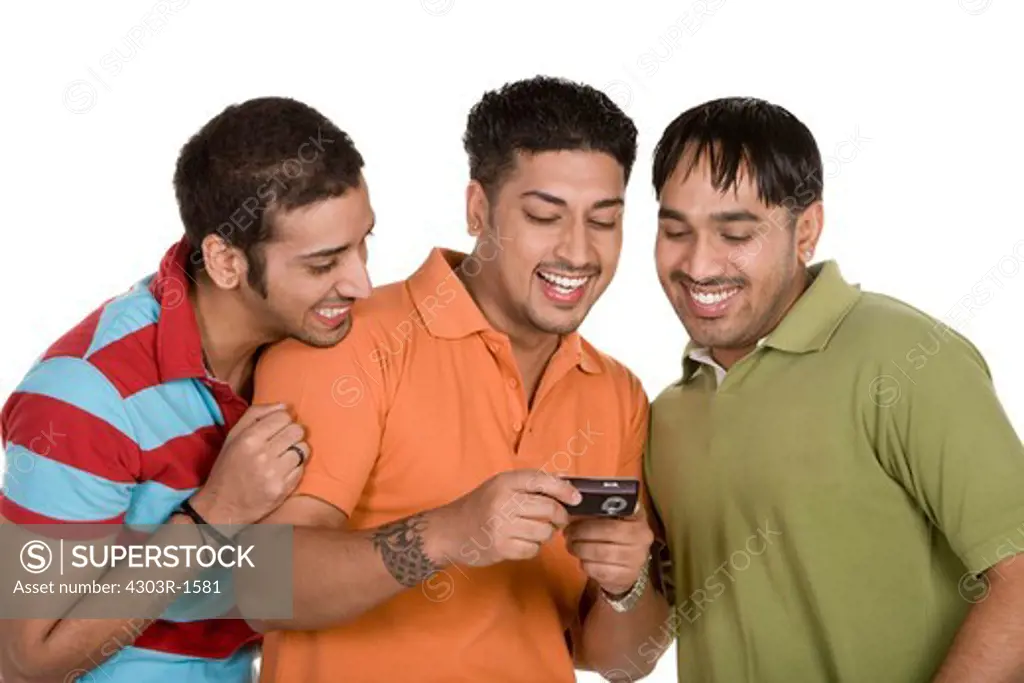 Friends reading text message, smiling