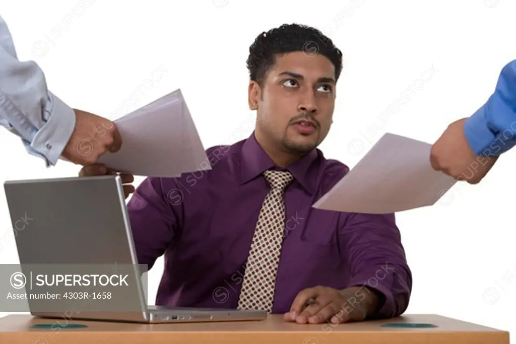 Businessman with laptop taking documents