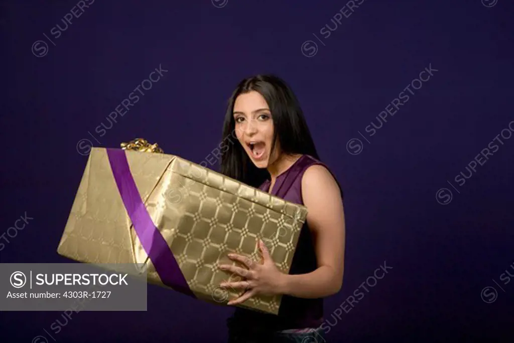 Young woman holding gift, portrait
