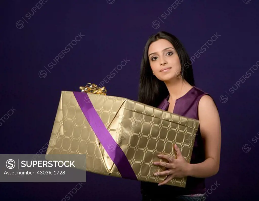 Young woman holding gift, portrait