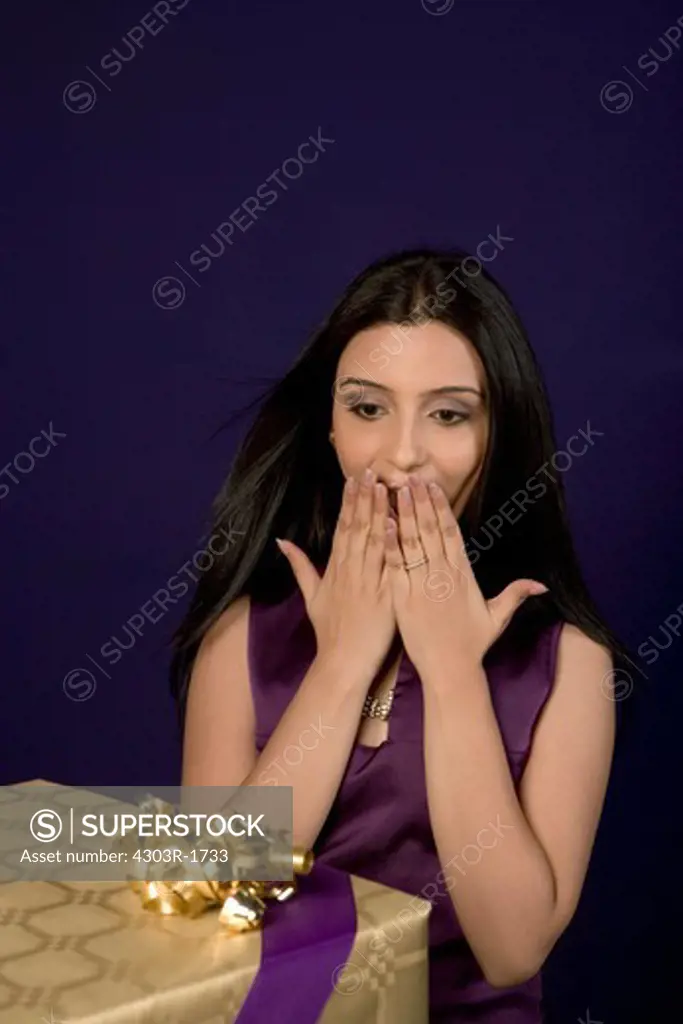 Young woman looking at gift