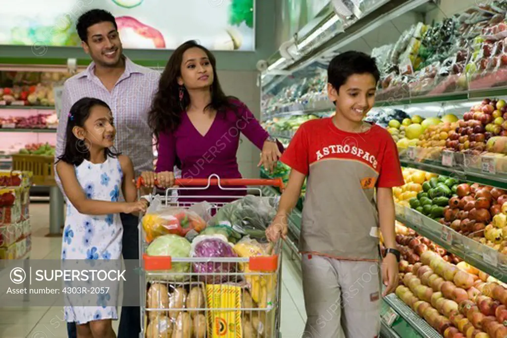 Family at supermarket, smiling