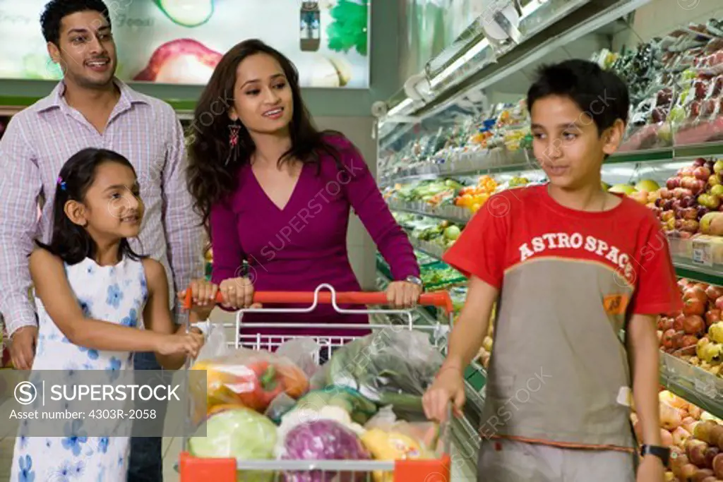 Family at supermarket, smiling