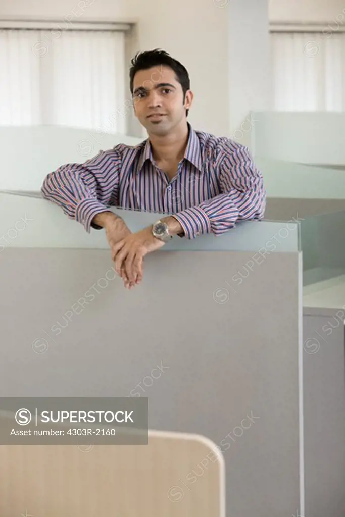 Businessman standing by the cubicle