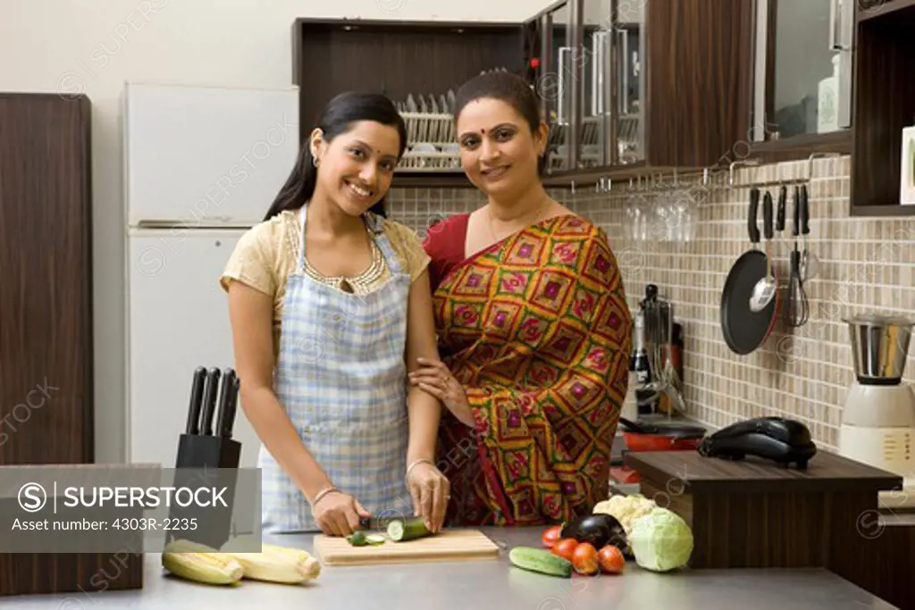 Mother and daughter preparing food in the kitchen
