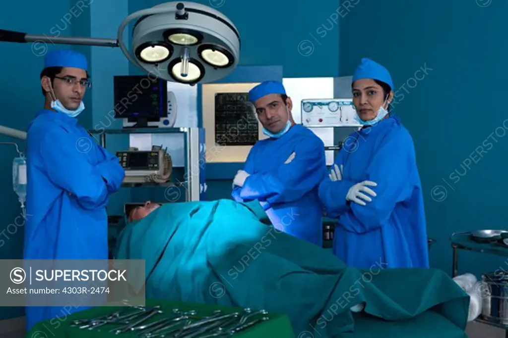 Three confident surgeons in the operating room