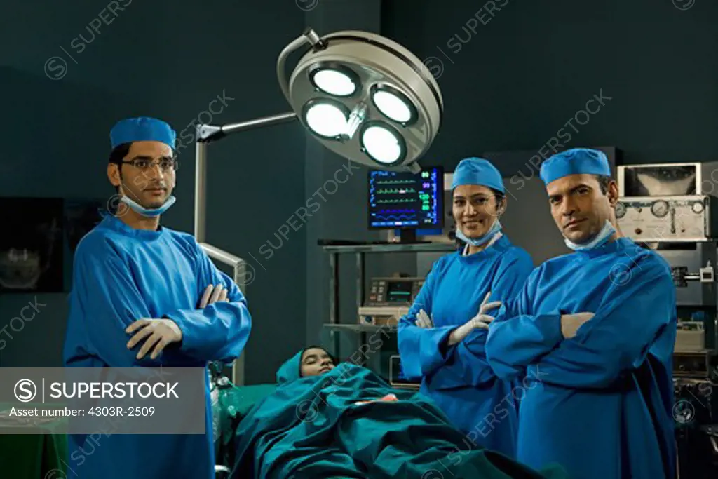 Three confident surgeons in the operating room