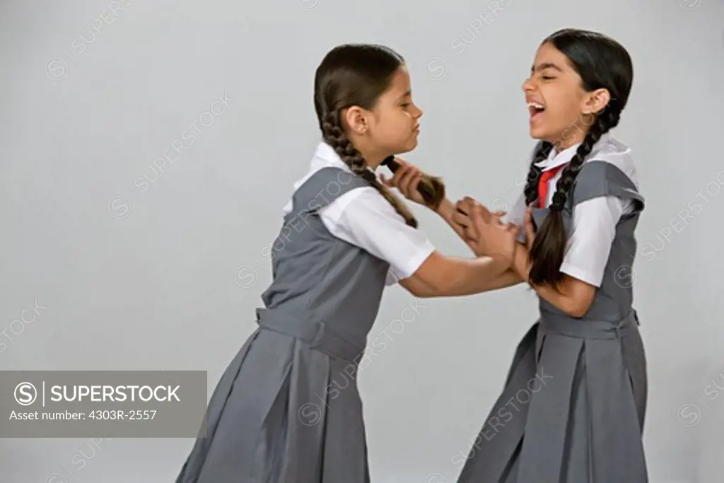 One naughty school girl pulling another girls hair