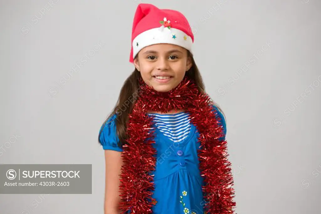 Girl wearing santas hat, smiling