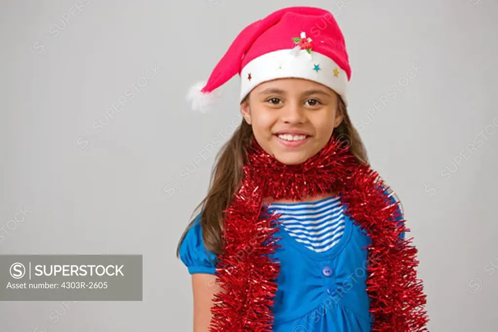 Girl wearing santas hat, smiling