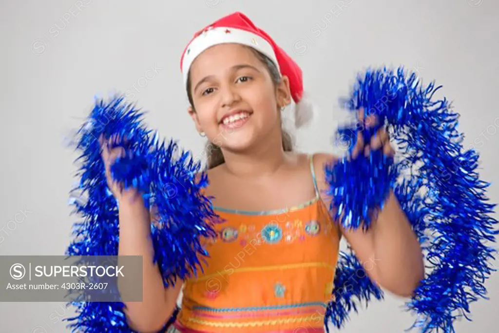 Girl wearing santas hat, dancing