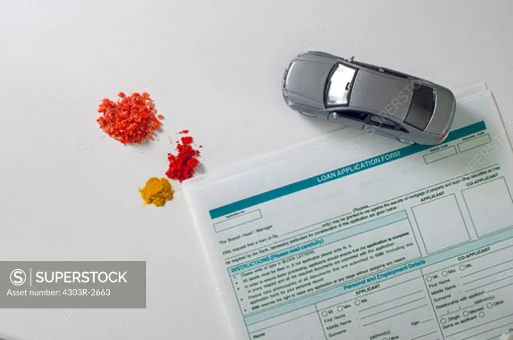 Traditional indian offerings with toy car and loan application forms
