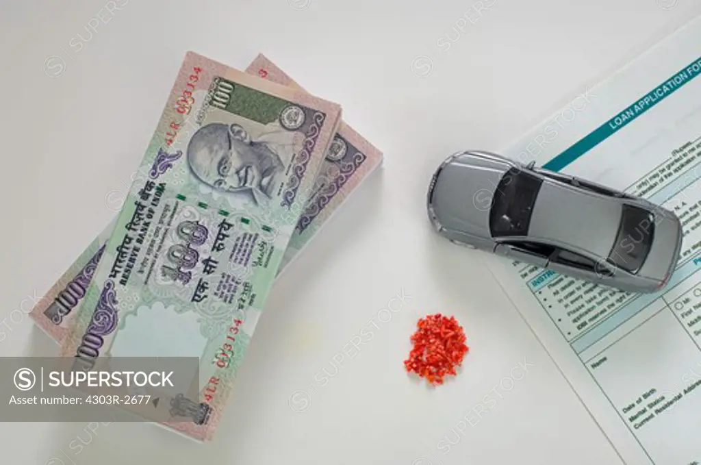 Traditional indian offerings with toy car and indian rupees