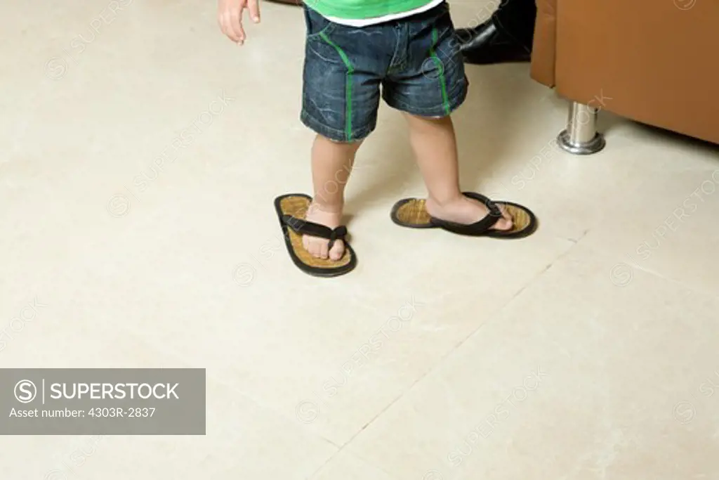 Boy wearing big slippers