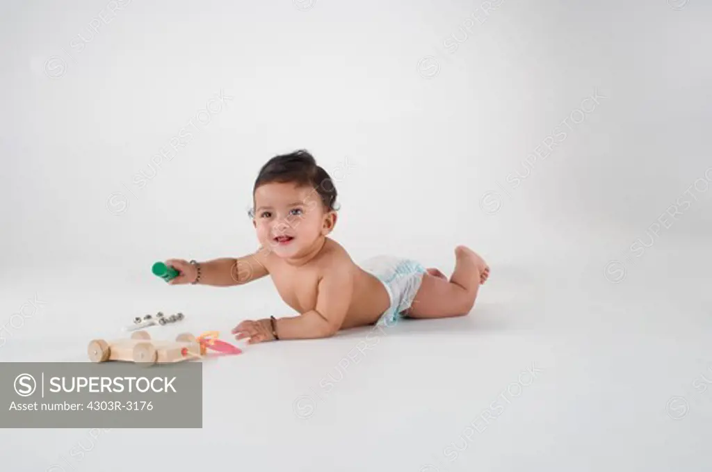Baby boy playing with toy, smiling