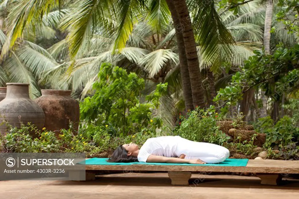 Woman in yoga position in the garden