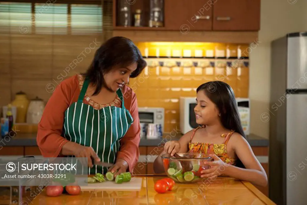Grandmother and granddaughter cooking in the kitchen