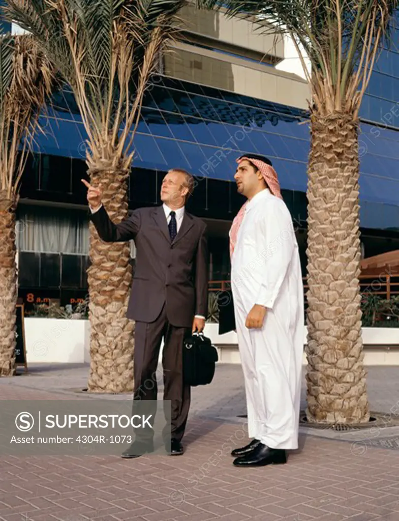 Caucasian & Arab Businessmen taking outdoors