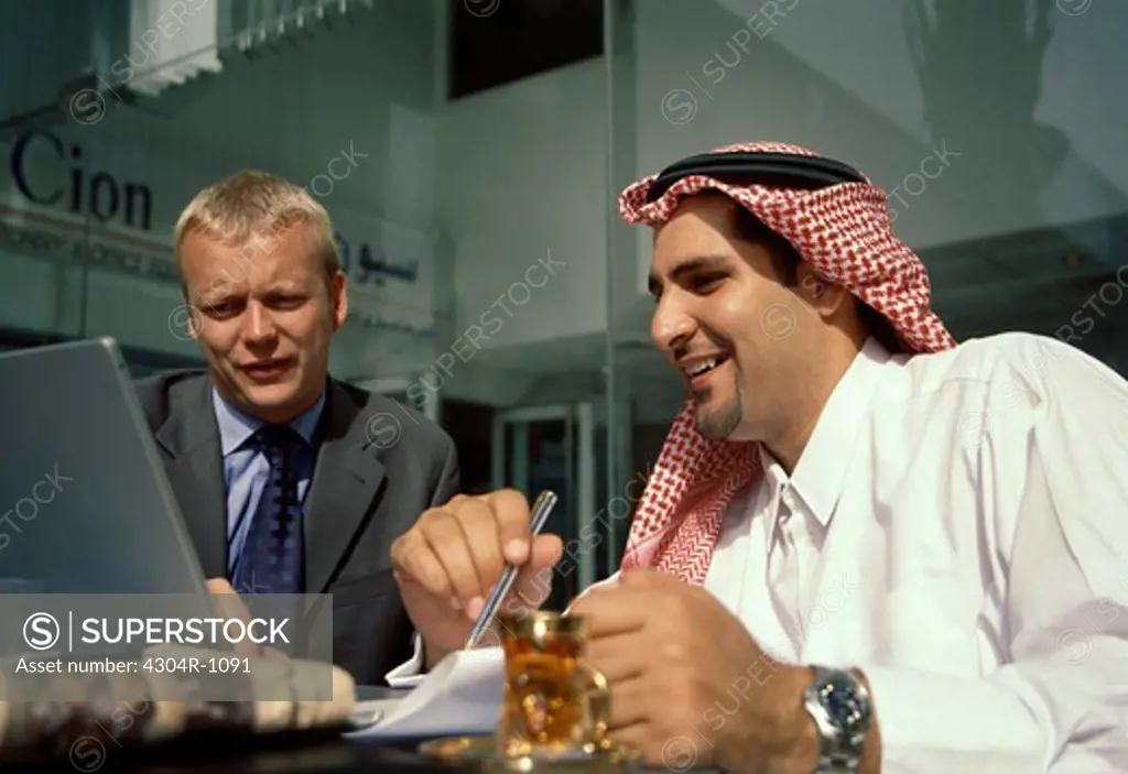 Two Business men at a cafe Discussing