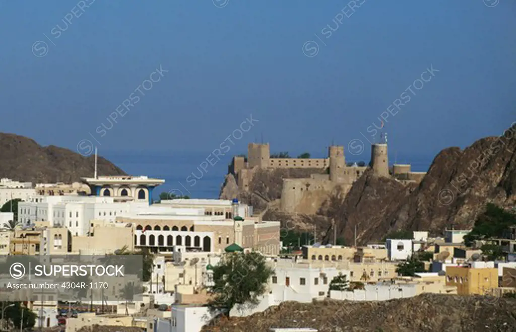 Fort and a mosque is seen near sea during the day.