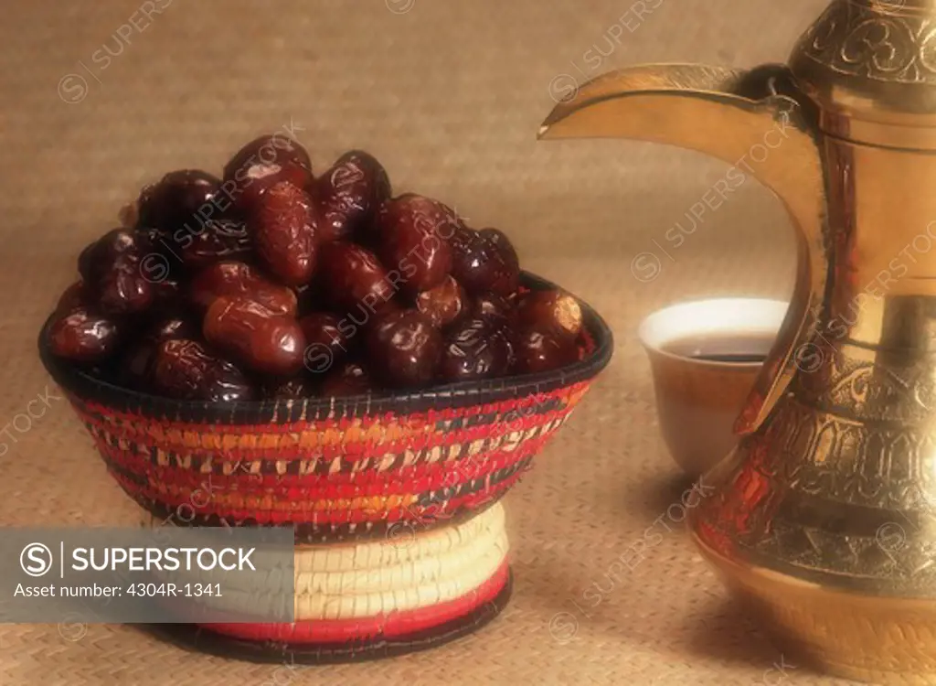 Basket full of dates and Coffee pot