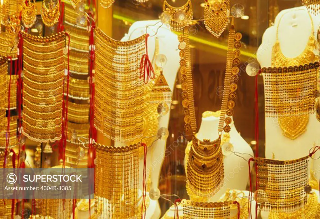 Window display of exquisite gold jewelry.