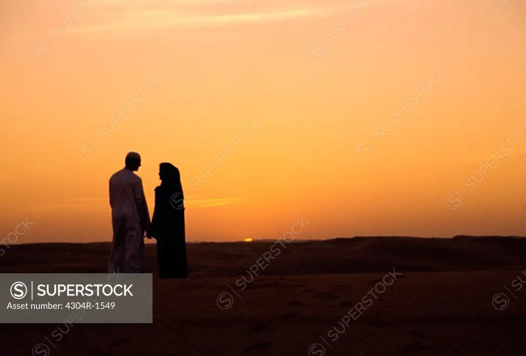Young Arab couple watching sunset