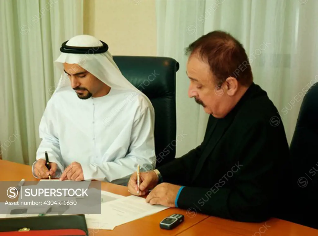 Businessmen signing a contract