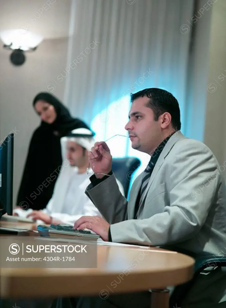 Arab men and woman in an office