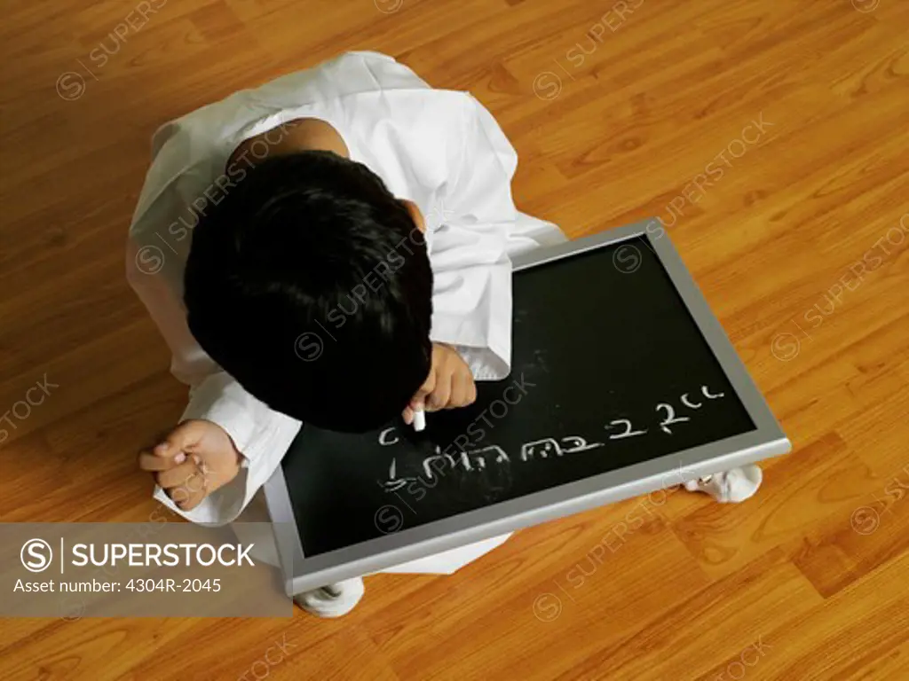 Arab Boy writing on slate