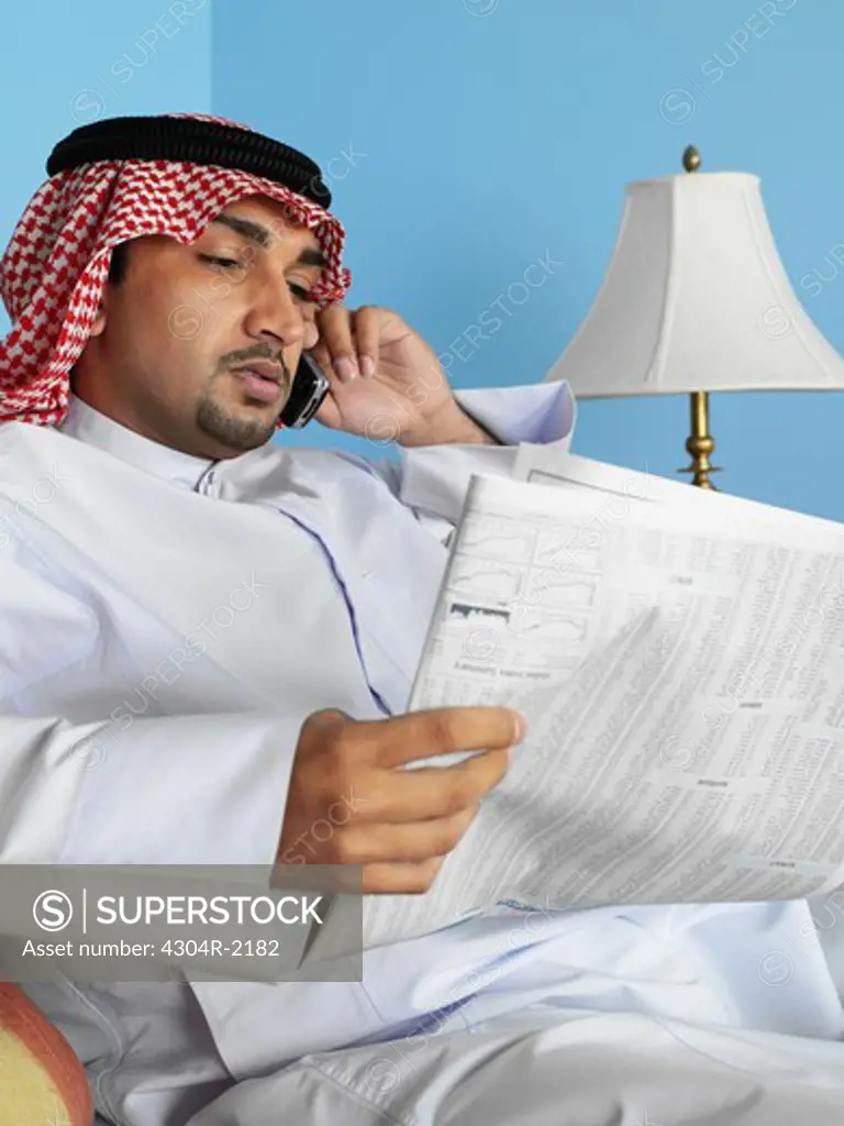 Arab man reading newspaper