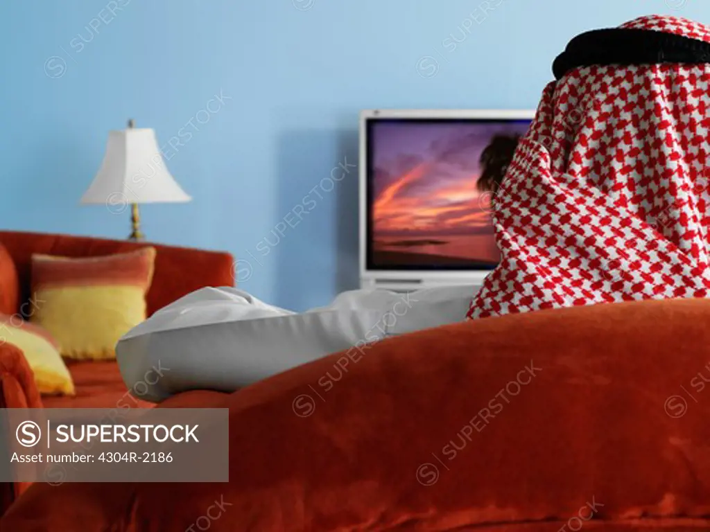 Arab man watching television