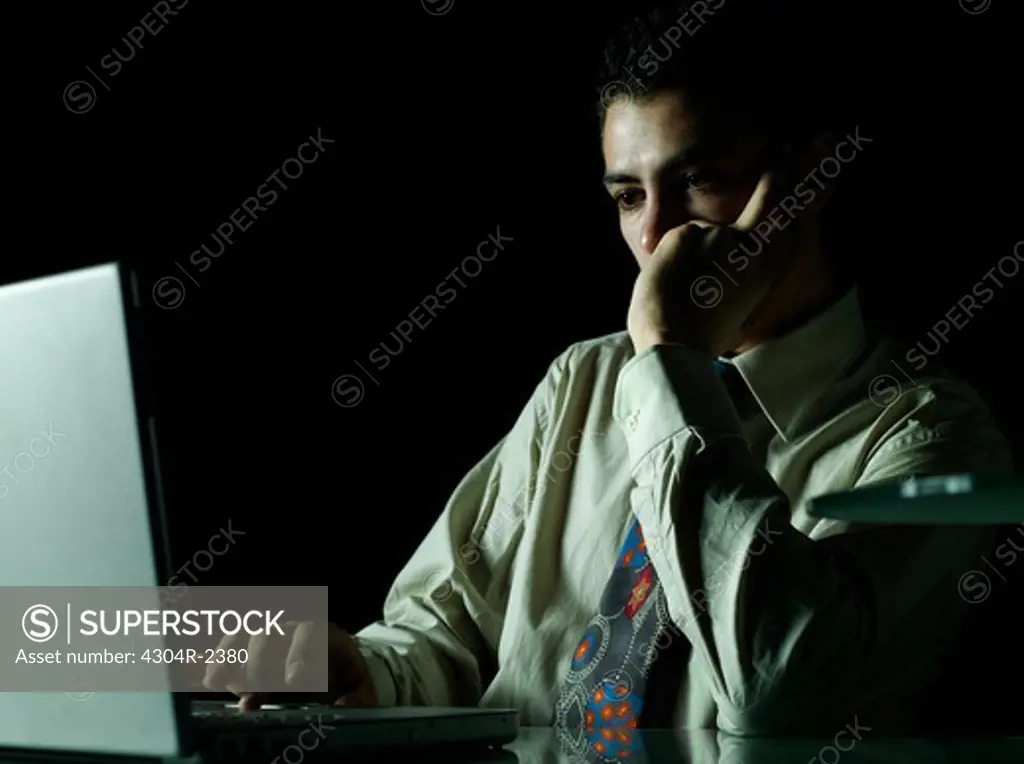 Young Businessman at table with laptop.