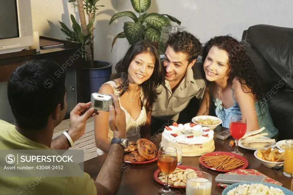 Young people socializing at home.