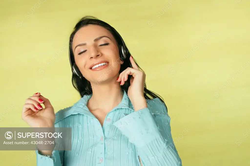 Lady enjoys listening the music.