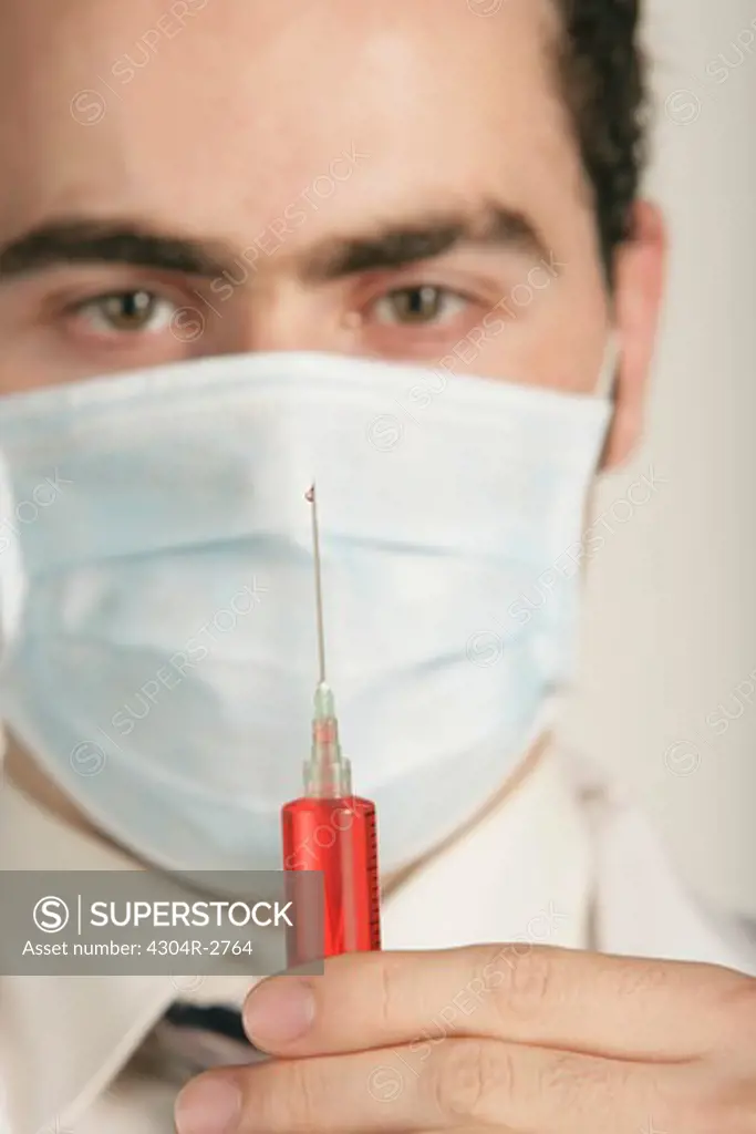 Doctor holding a syringe.