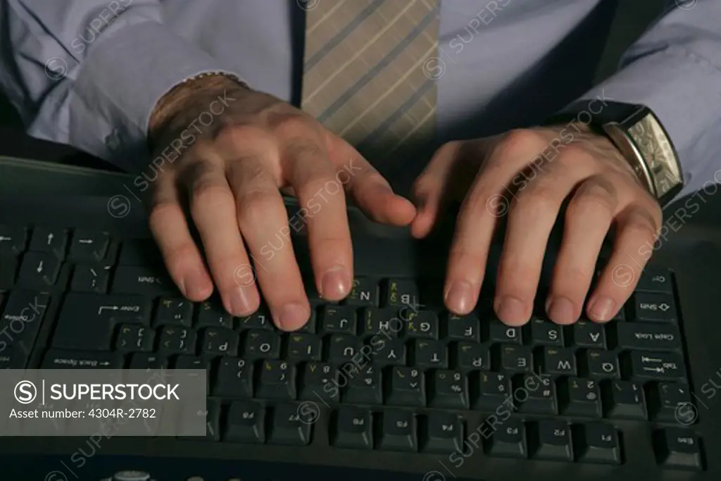View of businessman at keyboard.
